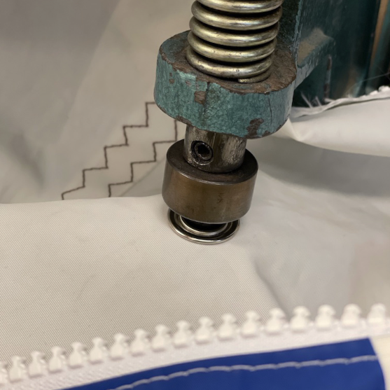 applying eyelets in sail bag